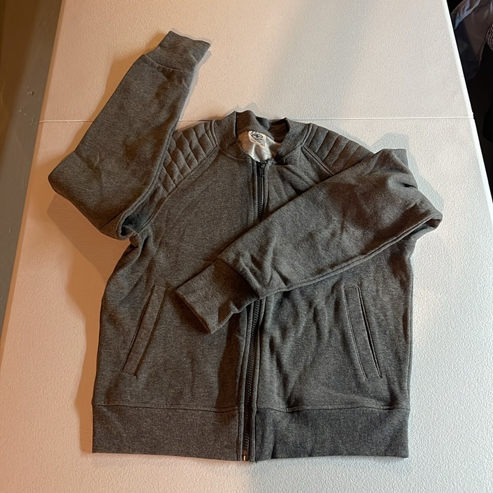 Gray sweatshirt with holes for thumbs